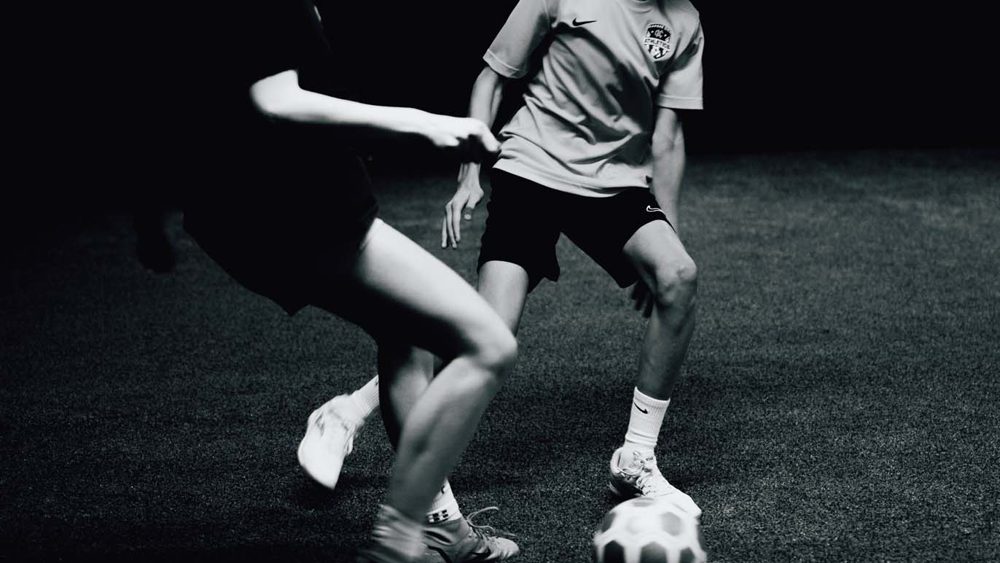 Youth players in a 1-on-1 drill on the indoor turf at Prestige Indoor Sports in Overland Park