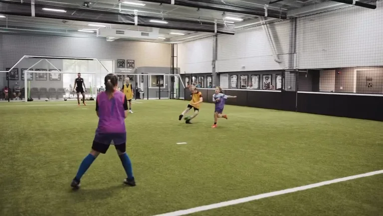 A small-sided game under way across the full indoor turf at Prestige Indoor Sports