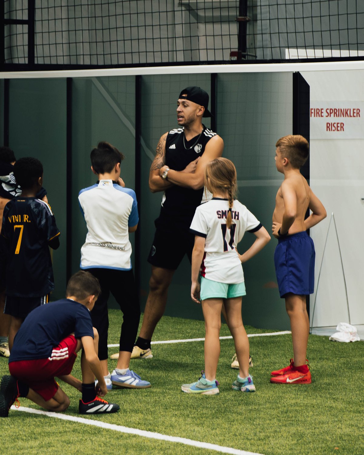 A Prestige coach with a group of young players during a training session